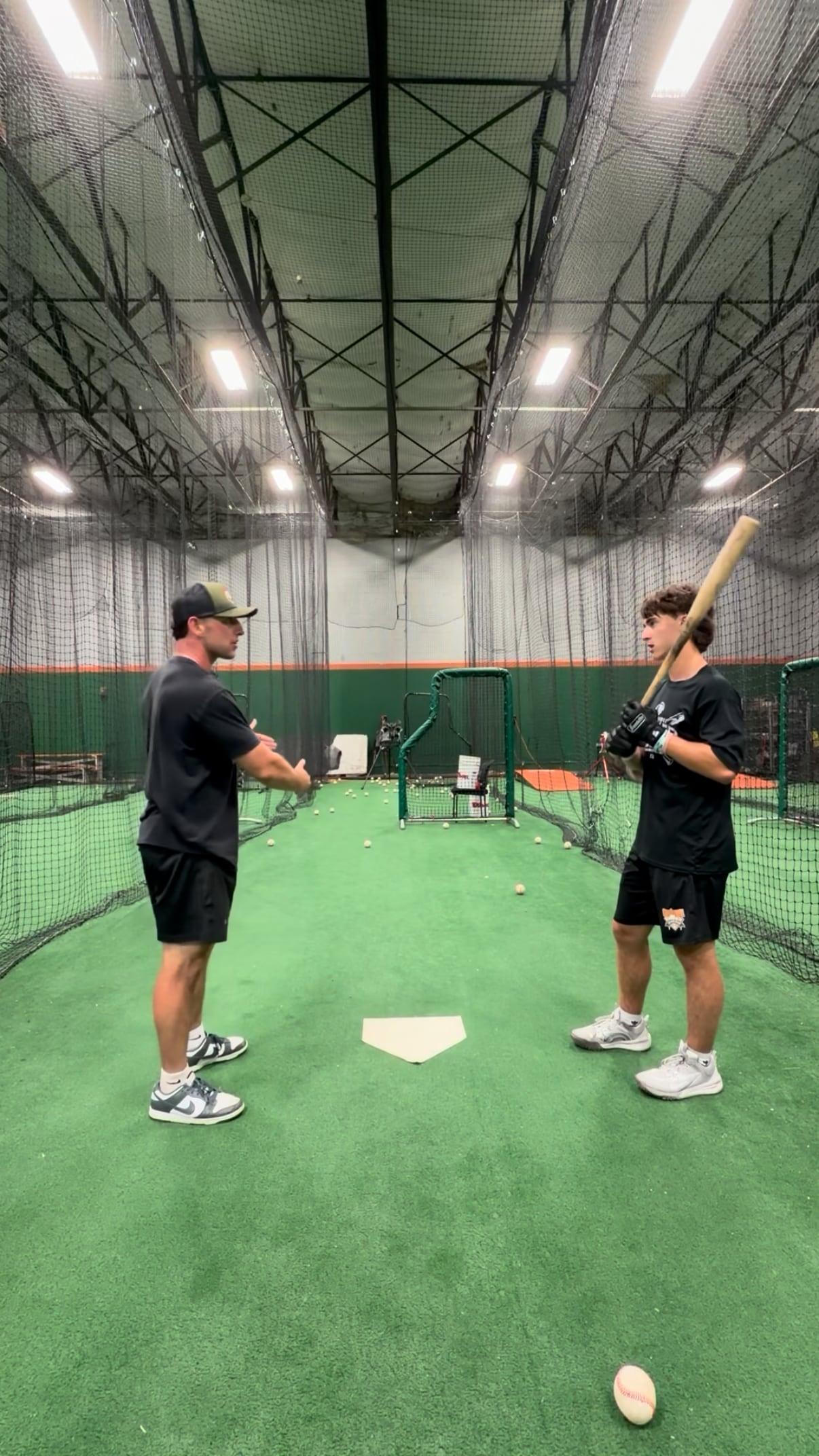 Ben Beauchamp working one-on-one with a hitter in the cage